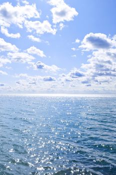 Blue ocean water and sunny sky background