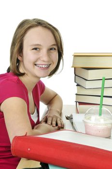 Teenage school girl studying with a milkshake