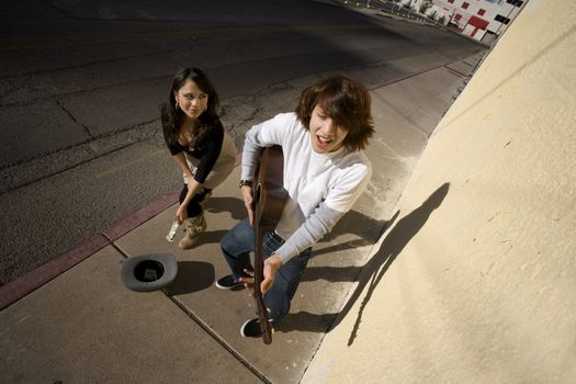 Musician on Sidewalk and Woman Pedestrian