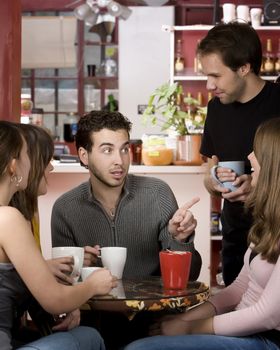 Five young friends in a coffee house