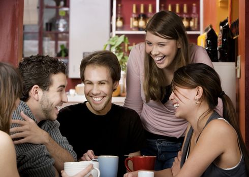 Five young friends in a coffee house