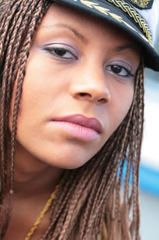 close-up portrait of the beautiful girl in captain cap