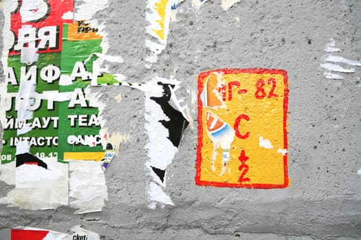 Texture, Varicolored Concrete Wall with Scrap of the Posters and Pointer of the Main Gasmain, Background