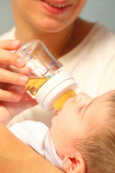 ma feeds tiny infant from bottle