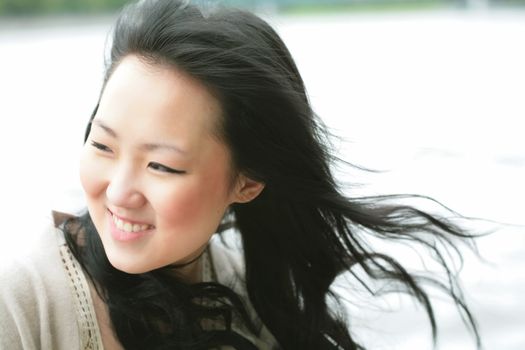 close-up portrait of the beautiful orient girl on wind