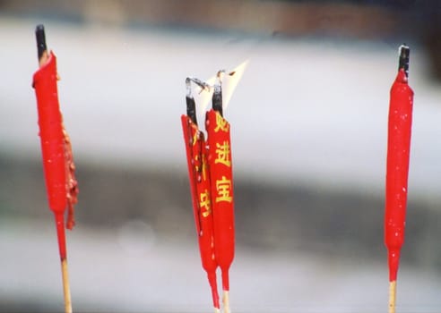 Buddhist's temple in Guangdong province, China with typical red candles with wishes.