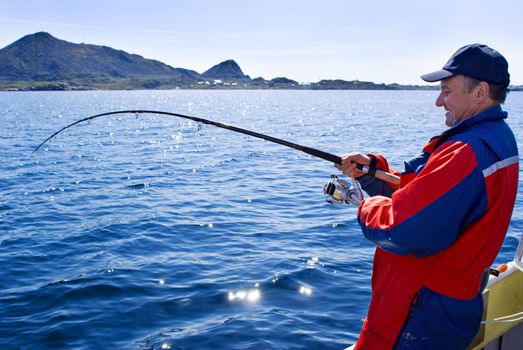 Fisherman with fish on the boat near the Lofoten island