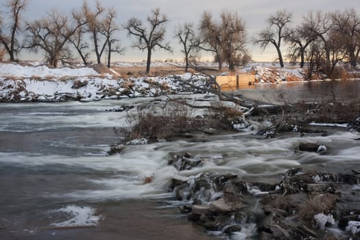 one of many dams on South Platte River in Colorado diverting water for farmland irrigation, ditch headgate (inlet), winter scenery