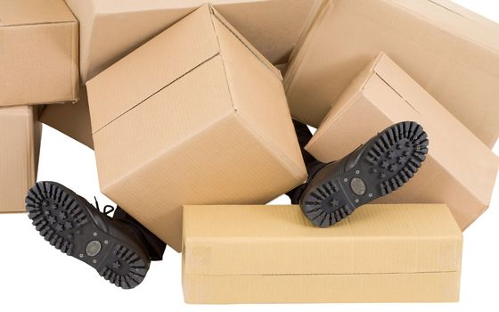 Male feet sticking out from under heaps of boxes