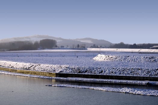 River with snow and ice on the coast