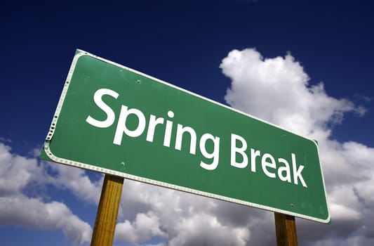 Spring Break Road Sign with Dramatic Clouds and Sky
