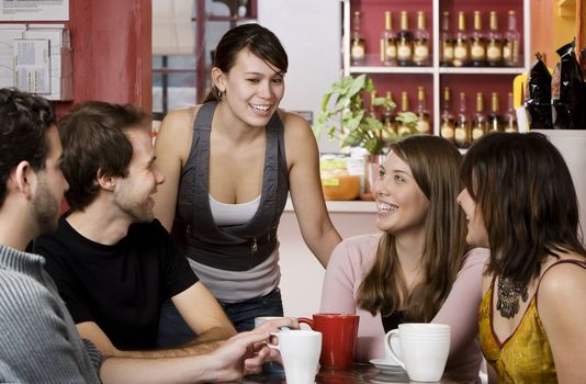 Five young friends in a coffee house