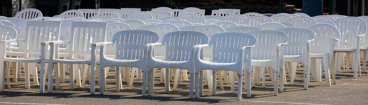 White plastic chairs lined up for a wedding