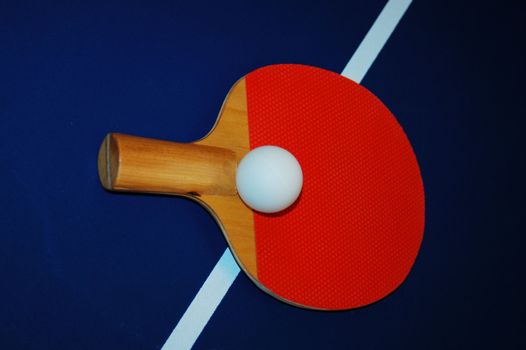 ping pong paddle and ball on a table