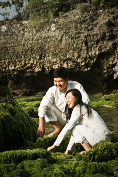 A young couple spending time together by playing water