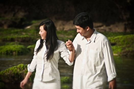 Young couple walking and holding hands