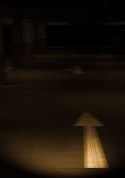 direction arrow on the pavement of a Parking garage