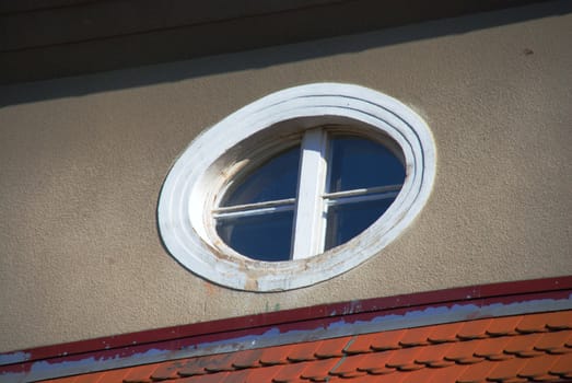Round window in the building of multi-family.