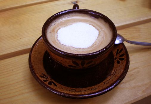 cup of coffee on wooden table  