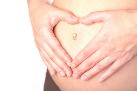 belly and hands of the pregnant woman on white background