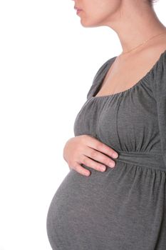beautiful expectant mother in gray knitted dress on white background