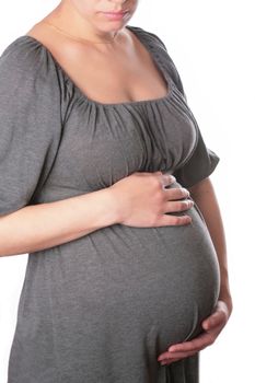 beautiful expectant mother in gray knitted dress on white background