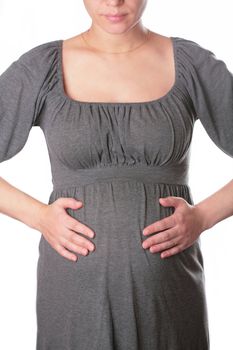 beautiful expectant mother in gray knitted dress on white background