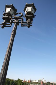 Old-time Moscow Torch on Background Blue Sky, Silhouettes Kremlin