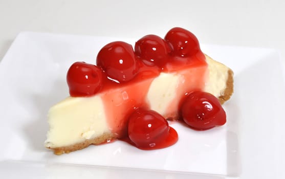 Cherry cheesecake isolated on white background.