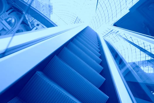 Blue moving escalator in the shopping center