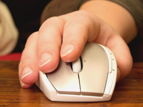 Human hand using scroll wheel on computer mouse