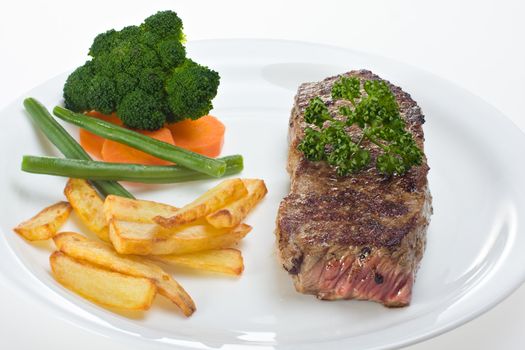 grilled steak on a plate with fries