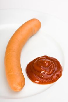 a pair of wieners on a white plate