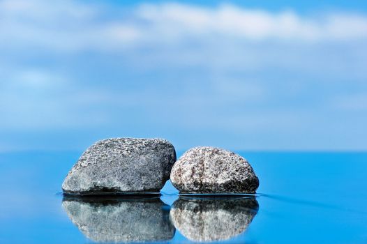 Stones on a smooth surface against the dark blue sky