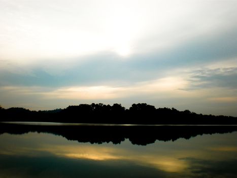 Reflection of the sun, clouds and sky on the waters