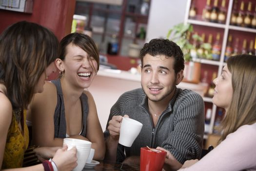 Handsome young man in a coffee house surrounded by pretty women