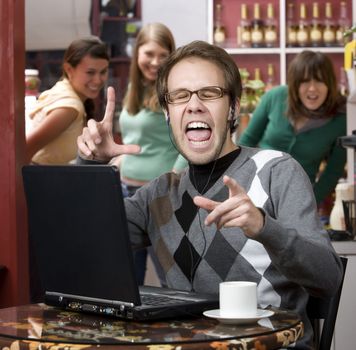 Obnoxious young man singing loudly in a coffee house