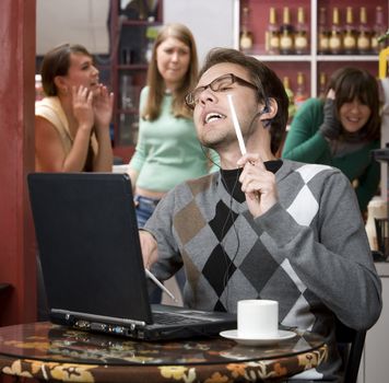 Obnoxious young man singing loudly in a coffee house