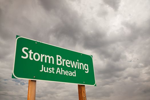 Storm Brewing Just Ahead Green Road Sign with Dramatic Storm Clouds and Sky.