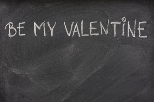 be my Valentine phrase handwritten with white chalk on blackboard with eraser smudges