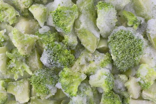 frozen diced green broccoli background with ice and frost