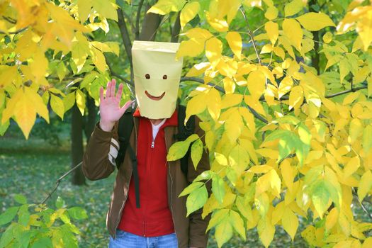 Merry Funny Smiling Man appeared from behind the Yellow Leafs, Fun, Humor