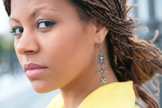 close-up portrait african girl with exotic hairstyle in yellow cloth