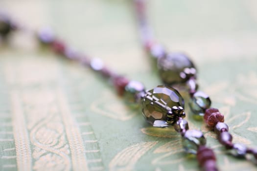 Fragment of necklace, crystalline transparent bead, macro