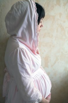 expectant mother in soft robe, morning near window