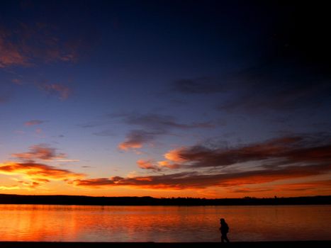 Sunrise landscape with person walking on a beach in colorado