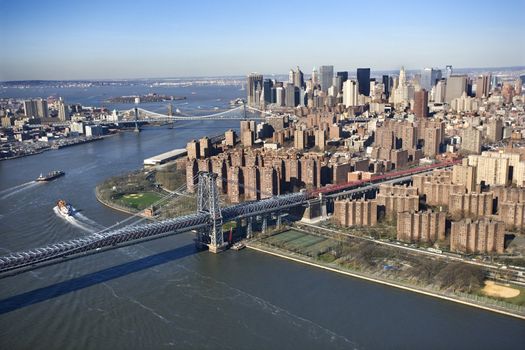 Aerial view of in New York City Williamsburg Bridge with Manhattan and Brooklyn bridges in background and view of lower east Manhattan.