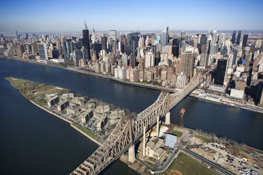 Aerial view of Queensboro Bridge in New York City with Rooseveldt Island and Manhattan cityscape.