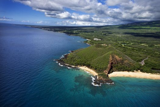 Aerial of Maui, Hawaii coastline with crater and cliffs and beach on Pacific ocean.