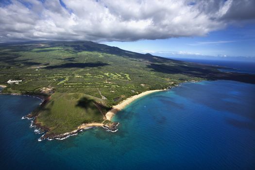 Aerial of coastline with sandy beach and crater and Pacific ocean in Maui, Hawaii.